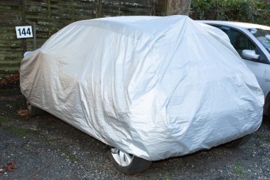 Car covered with waterproof cloth soft cover in street