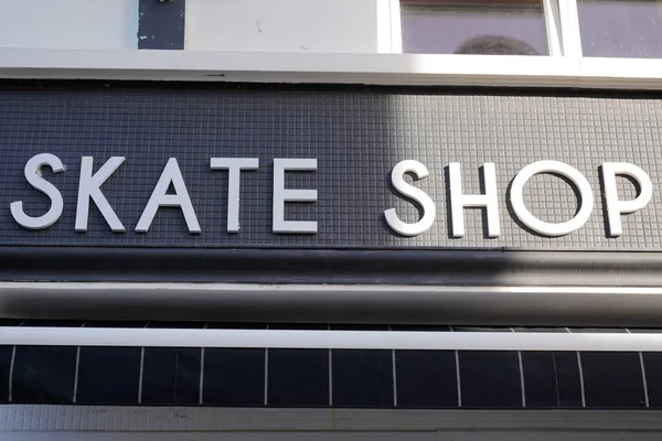 skate shop text sign facade store logo in city street specialized in skateboard