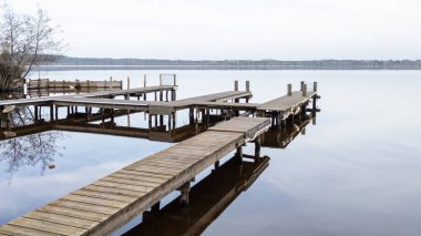 wooden pontoon boat coast beach aside Leon lake water in southwest france clipart