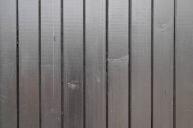 Gri çitlerin ön cephesinde tahta tahtaların dikey desenli gri ahşap arka planı