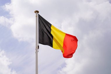 belgium flag belgian wave over a cloudy sky