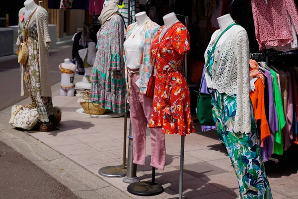 clothes shop in city street on front of store fashion dress women clothing outdoors boutique market