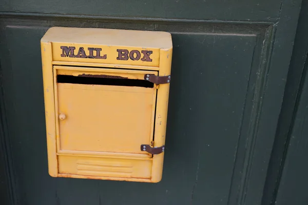 mail post text sign on yellow old private mailbox of vintage house