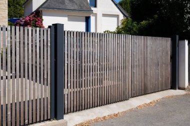 Brown entry wooden gate closed of modern house suburb wood portal access home door