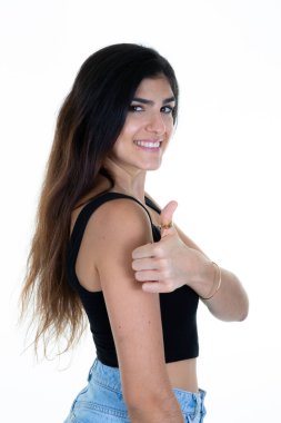 beautiful brunette woman with hand  thumb up success sign positive gesture smile and happiness over isolated white background