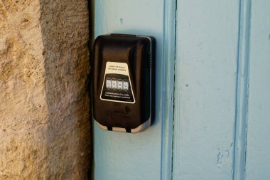 Bordeaux , Aquitaine  France - 08 15 2022 : Master lock light up dials logo brand and text sign on keys box in home door rental facade