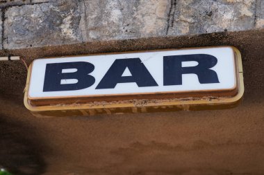 text bar on facade wall front building entrance cafe pub in street