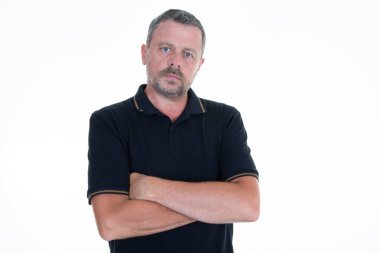 serious middle aged man isolated on white background folded keeping the arms crossed in frontal position