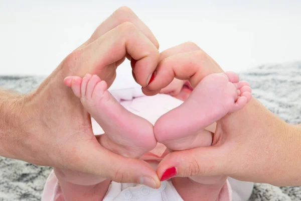 Mother father holding feet newborn baby foot love at first sight kids feels love and security from parents