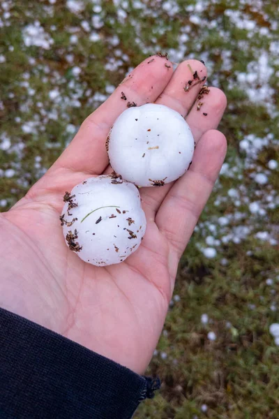 large hail on human palm close up after hailstones thunderstorm