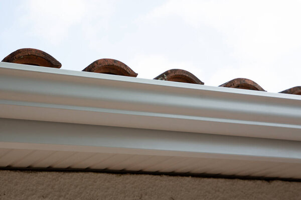 White gutter new modern on the roof top of house