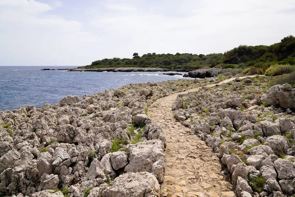 stones rocks path access to sea beach in south Antibes France southeast