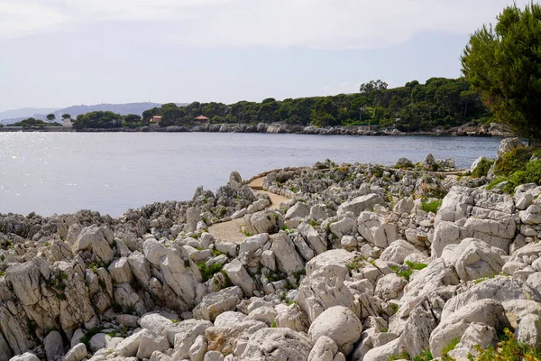 passage pedestrian path by the sea on the tourist coast mediterranean at edge of the rocks Juan-les-Pins in Antibes France