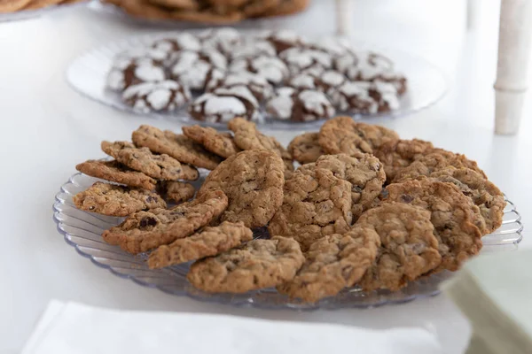 Delicious serve yourself offering of chocolate chip cookies on a plate for all the wedding guests to eat after dinner.