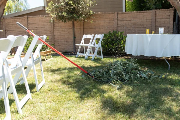 Backyard venue needs some leaves raked to clean up the grass before the party.