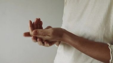 Kadın ellerine krem sürüyor. Ev bakımı. Sabah vücut bakımı. El masajı, rahatlama. 