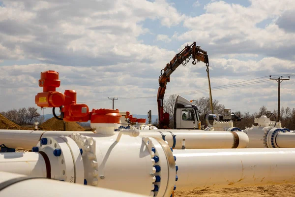 Worker works on a construction site of an interconnected natural gas transmission pipeline. Highly integrated network that moves natural gas. Connection point between the transmission company and the receiving party.