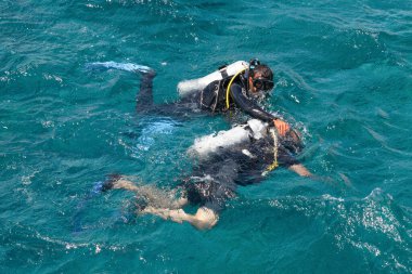 Kızıl Deniz 'in sularında bir eğitmenle tüplü dalışın başlangıcı, ilk ortak dalış, su altında doğru nefes alma eğitimi, tüplü dalış ekipmanları