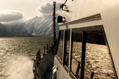 View of Volcano Vilyuchinsky from bow of the cruise ship. Sunbeams penetrate the sunset clouds. Kamchatka Peninsula, Russia. clipart