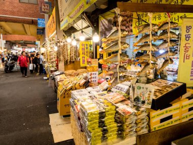 Seoul, South Korea - June 26, 2017: People buying tasty food and drink at Gwangjang Market in Seoul. One of the most popular street food place where you can buy kimbap, teokbokki, bibimbap, kimchi.
