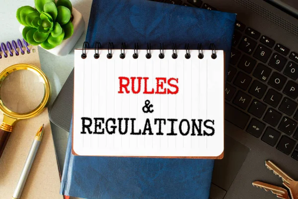 Torn Brown Paper Green Surface Rules Regulations Words — Stock Photo, Image