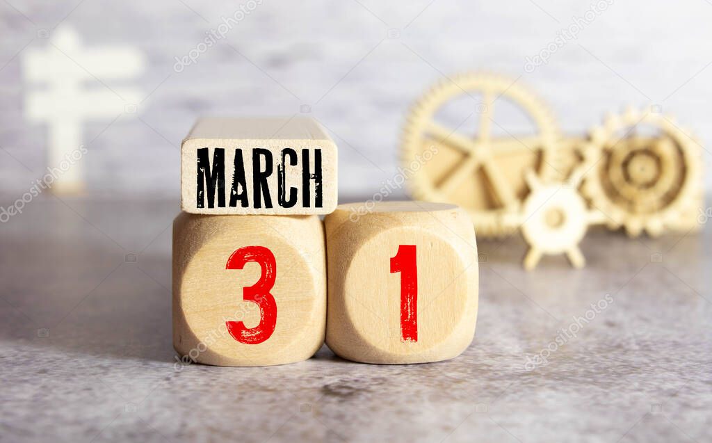 MARCH 31st. Image of MARCH 31 wooden color calendar on white wood wall background. empty space for text
