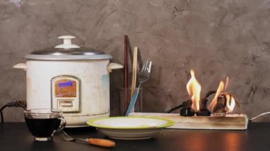 Fire and smoke from plugging the power cord into an overloaded electrical outlet. The concept of the dangers of using poor-quality equipment