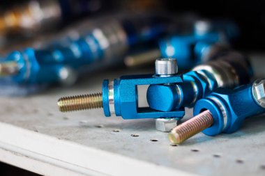 Blue nuts and bolts set Tools for work laying on a steel table for a blurred background