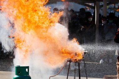 Demonstrate or simulate a burning flame. This is caused by the oil in the pan that is overheating. or a gas leak