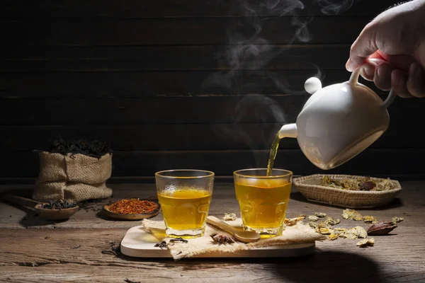 Brew hot tea, chrysanthemum tea, and chrysanthemum flowers. Safflower arranged on a wooden table Healthy drinks to drink herbs and medical concepts