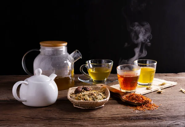Brew hot tea, chrysanthemum tea, and chrysanthemum flowers. Safflower arranged on a wooden table Healthy drinks to drink herbs and medical concepts