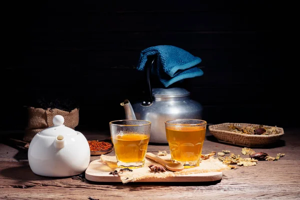 Brew hot tea, chrysanthemum tea, and chrysanthemum flowers. Safflower arranged on a wooden table Healthy drinks to drink herbs and medical concepts