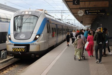 Uppsala, Sweden - July 2, 2022: Arriving SL commuter train class X60 at the Uppsala Central station.