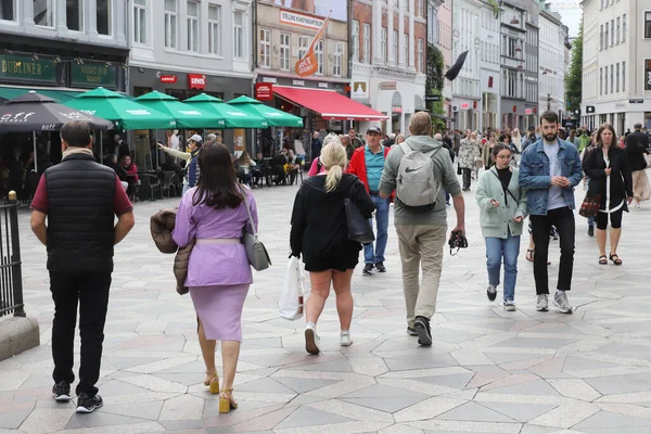 Copenhagen, Denmark - June 14, 2022: People stroilling at the Amagaertorv square at the Stroget shopping street.