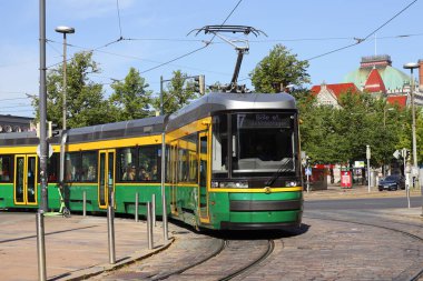 Helsinki, Finland - August 20, 2022: Articulated low-floor class MLNRV III Artic modern tram in service on line 7 at the Central railroad station area.