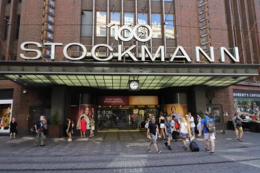 Helsinki, Finland - August 20, 2022: People at the entrance to the Stockmann department stores at the  Aleksanterinkatu street.
