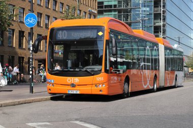 Helsinki, Finland - August 20, 2022: Orange electric articulated city bus on line 40 at the Central railroad station.