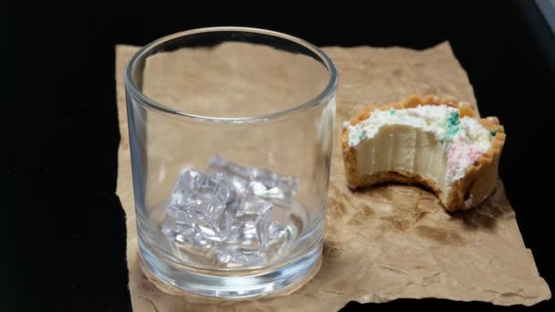 Ice Whiskey Being Poured Glass Alongside Mini White Chocolate Gancahe — Stockvideo