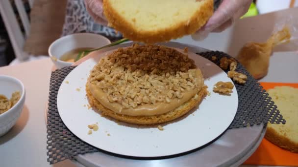 Selective Focus Confectioner Placing Layer Cake Dulce Leche Walnut Filling — стоковое видео