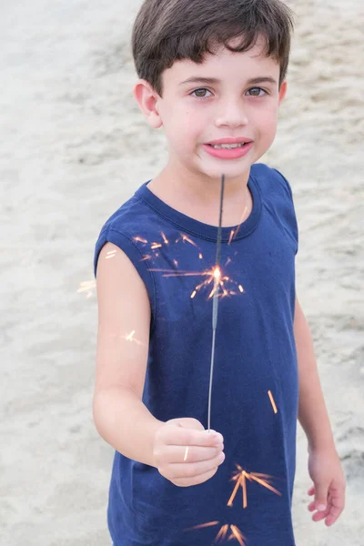 Smiling Brazilian Child Holding Candle Sparkles Beach Sand Vertical Photo — Stockfoto