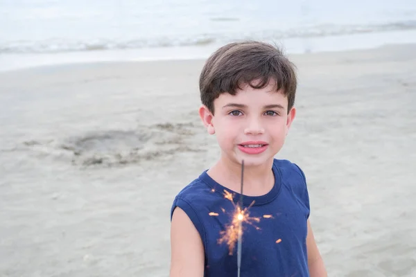 Smiling Brazilian Child Holding Candle Sparkles Beach Sand — стоковое фото
