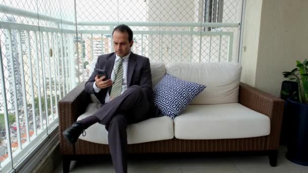 Homme Costume Assis Sur Canapé Dansant Avec Smartphone Écouteurs — Video