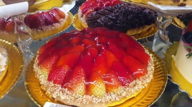 Strawberry pie topped with sugar syrup and chopped cashews.