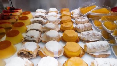 Various traditional sweets in a Brazilian bakery showcase. Made with flour, eggs, sugar, cream and milk.