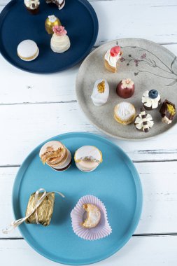 Stacked macarons surrounded by Wedding sweet treats, truffles and walnut cameo_vertical.