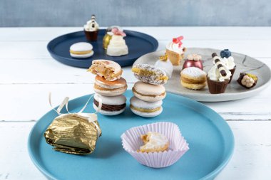 Stacked macarons surrounded by Wedding sweet treats, truffles and walnut cameo_side view.