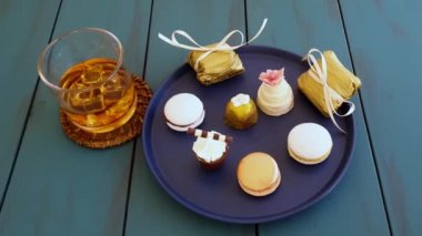 Man getting a wedding sweet treat alongside other sophisticated Brazilian wedding sweets.