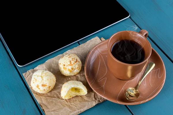 Closeup Brazilian Cheese Breads Brown Paper Next Tablet Cup Coffee — Stock Photo, Image