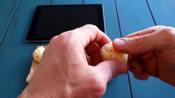 Man Taking Brazilian Cheese Rolls Splitting Them Half Next Tablet — 비디오