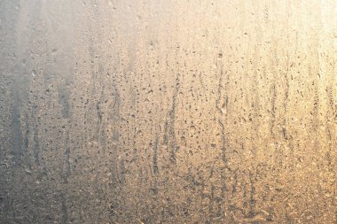 Pencerede buz ve güneş ışığı var. Donmuş kış camı. Buz dokusu.